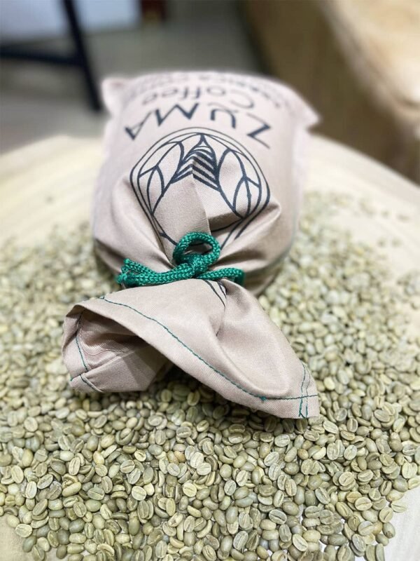 zuma sac of beans on top a pile of green coffee beans