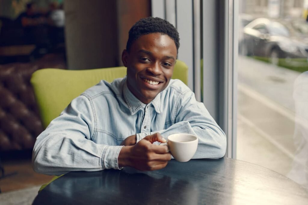 black-man-sitting-cafe-drinking-coffee