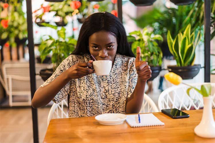 woman-tasting-coffee-in-a-cafe