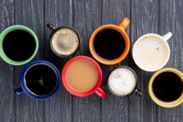 Top view of 8 cups of different types of coffee - Learn home brewing at Zuma coffee