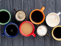 Top view of 8 cups of different types of coffee - Learn home brewing at Zuma coffee