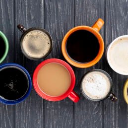 Top view of 8 cups of different types of coffee - Learn home brewing at Zuma coffee