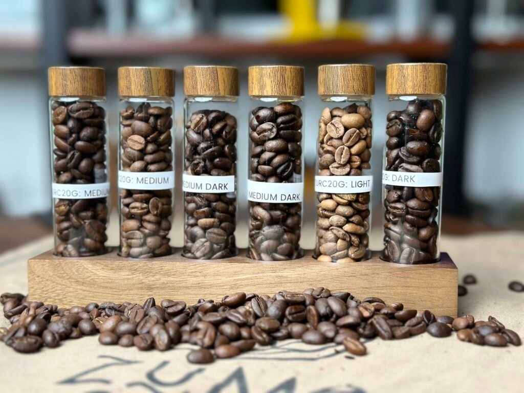 different roast levels of coffee beans in air tight containers...some coffee beans on the table by the container