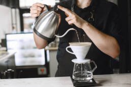 Black ground coffee. Barista brews a drink. Coffee in a glass jug - barista in Abuja