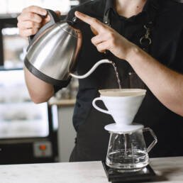 Black ground coffee. Barista brews a drink. Coffee in a glass jug - barista in Abuja