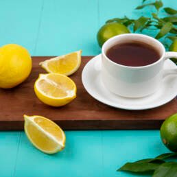 tpf view of coffee and lemon on a brown wooden stand