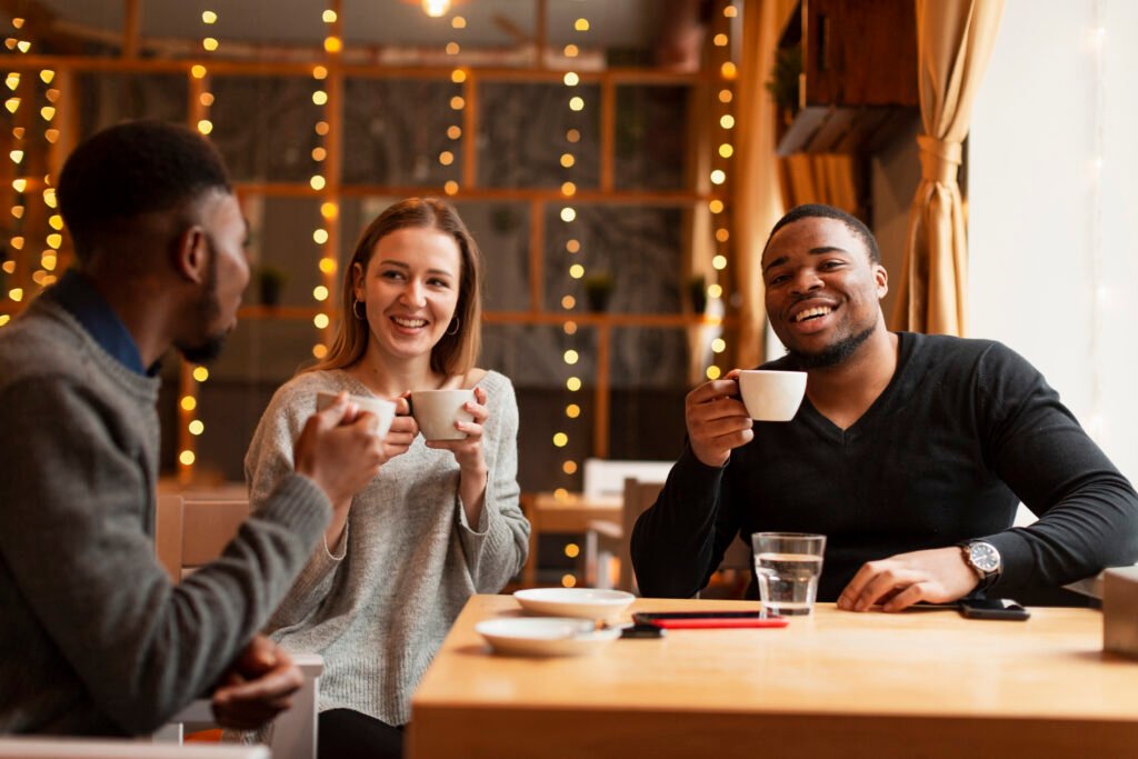 three people with cups of coffee in hand on a table as they celebrate coffee
